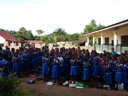 In 2012, older children pose in front of the structure under construction.