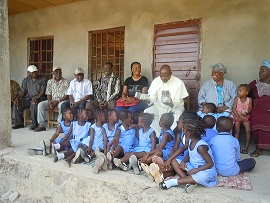 Fr.Combey presenting Money donated for the Pre school project to a section of Pre schoool children on the 21st January,2017.
